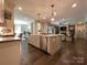 Open concept living room with a fireplace and built-in shelving seen from the kitchen at 3201 Johnny Cake Ln, Charlotte, NC 28226