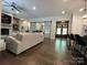 Open-concept living area featuring hardwood floors, a comfortable sofa, and stylish decor, perfect for entertaining at 3201 Johnny Cake Ln, Charlotte, NC 28226