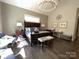 Comfortable main bedroom featuring a statement chandelier, stylish furnishings, and bright natural light at 3201 Johnny Cake Ln, Charlotte, NC 28226