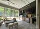 Relaxing screened patio with modern outdoor kitchen and comfortable seating area at 3201 Johnny Cake Ln, Charlotte, NC 28226