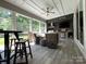 Outdoor patio with comfortable seating, dining area, ceiling fan, and outdoor kitchen at 3201 Johnny Cake Ln, Charlotte, NC 28226