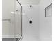 Modern bathroom features sleek glass shower and stylish white tiled walls with dark fixtures at 3220 Riley Ave, Charlotte, NC 28269