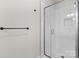 Modern bathroom features a glass-enclosed shower with white subway tile and black hardware at 3220 Riley Ave, Charlotte, NC 28269