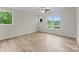 Bright, airy bedroom with multiple windows offering lots of natural light and wood-look floors at 3220 Riley Ave, Charlotte, NC 28269