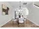 A dining area with a modern glass table and white chairs near the kitchen at 3220 Riley Ave, Charlotte, NC 28269