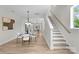 Bright dining area with a stylish table setting and stairs leading up, creating an inviting and functional space at 3220 Riley Ave, Charlotte, NC 28269