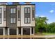 Beautiful townhome with a modern design and a well-kept lawn and bench, perfect for enjoying the outdoors at 3220 Riley Ave, Charlotte, NC 28269