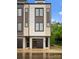 Striking townhome showcasing large windows and a modern garage door, complemented by a well-maintained lawn at 3220 Riley Ave, Charlotte, NC 28269
