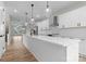 Open-concept kitchen with a large island, stainless steel appliances, and white cabinetry, ideal for entertaining at 3220 Riley Ave, Charlotte, NC 28269