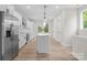 Modern kitchen with stainless steel appliances, a large center island, and bright white cabinets, perfect for cooking at 3220 Riley Ave, Charlotte, NC 28269