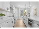 Modern kitchen with white subway tile, stainless steel appliances, and a large window for natural light at 3220 Riley Ave, Charlotte, NC 28269
