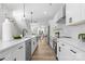 Well-lit kitchen featuring white cabinetry, stainless steel appliances, and an island with a black faucet at 3220 Riley Ave, Charlotte, NC 28269