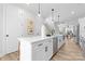 Bright kitchen with modern lighting, stainless steel appliances, and an island with white countertops at 3220 Riley Ave, Charlotte, NC 28269