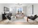 Living room features a large window, light colored walls and modern decor at 3220 Riley Ave, Charlotte, NC 28269