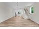 Open-concept living area showcasing modern flooring, staircase, and a view into the kitchen at 3220 Riley Ave, Charlotte, NC 28269