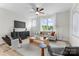 Living room features a large window, light colored walls and modern decor at 3220 Riley Ave, Charlotte, NC 28269