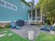Backyard patio with pavers, outdoor seating, grill, screened-in porch, and well-maintained landscaping at 332 Delburg St, Davidson, NC 28036