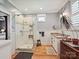 Bright bathroom with a walk-in shower, single vanity, and modern fixtures at 332 Delburg St, Davidson, NC 28036