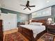 Comfortable bedroom with ceiling fan, natural light, and hardwood floors at 332 Delburg St, Davidson, NC 28036