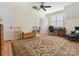 Bright bonus room with hardwood floors, ceiling fan, shuttered windows, desk space and comfortable seating at 332 Delburg St, Davidson, NC 28036