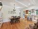Open dining area with hardwood floors, stylish chandelier, and easy access to the kitchen at 332 Delburg St, Davidson, NC 28036