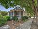 Charming exterior with a screened-in porch, lush landscaping, and a well-maintained walkway at 332 Delburg St, Davidson, NC 28036