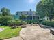 Home with a porch and lush landscaping, complemented by a stone patio and manicured shrubs at 332 Delburg St, Davidson, NC 28036