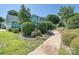 Beautiful home with a walkway, lush shrubs, and well-manicured landscaping at 332 Delburg St, Davidson, NC 28036