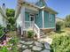 Charming home exterior with stone walkway, stairs leading to the entrance, and landscaping at 332 Delburg St, Davidson, NC 28036