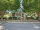 Charming home with a porch, front yard, and mature trees and landscaping at 332 Delburg St, Davidson, NC 28036