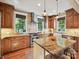Well-lit kitchen boasts granite counters, stainless steel appliances, and ample cabinet space at 332 Delburg St, Davidson, NC 28036