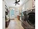 Well-organized laundry room and mudroom with modern washer, dryer and storage at 332 Delburg St, Davidson, NC 28036