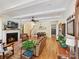 Bright, open living room with hardwood floors, fireplace, and seamless flow to the dining area and kitchen at 332 Delburg St, Davidson, NC 28036