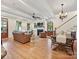 Spacious living room featuring hardwood floors, a cozy fireplace, and seamless transition to the dining area at 332 Delburg St, Davidson, NC 28036