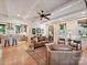 Bright living room with hardwood floors, a comfortable seating area, and an open flow to the kitchen at 332 Delburg St, Davidson, NC 28036