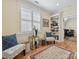 Cozy sitting area featuring shuttered windows, bookshelf, area rug, comfortable seating, and a view to the office at 332 Delburg St, Davidson, NC 28036