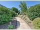 Sidewalk flanked by landscaping, mulch beds, shrubs, and trees at 332 Delburg St, Davidson, NC 28036
