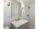 Modern bathroom featuring a shower with white subway tile and a gray vanity with marble countertop at 3620 Champaign St, Charlotte, NC 28210