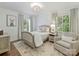 Charming bedroom with hardwood floors, a stylish chandelier, and large windows at 3620 Champaign St, Charlotte, NC 28210
