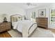 Bright bedroom with hardwood floors, a patterned rug, and a large dresser at 3620 Champaign St, Charlotte, NC 28210