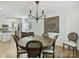 Bright dining room with hardwood floors, modern chandelier, and view into kitchen at 3620 Champaign St, Charlotte, NC 28210