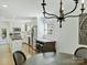 Dining room showcasing hardwood floors and modern chandelier with kitchen view at 3620 Champaign St, Charlotte, NC 28210
