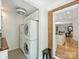 Laundry room with a stacked washer/dryer and view into kitchen at 3620 Champaign St, Charlotte, NC 28210