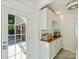Well lit laundry room with built-in cabinetry, baskets, and access to outdoors at 3620 Champaign St, Charlotte, NC 28210
