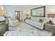 Open-concept living area with neutral furniture, hardwood floors, and large mirror accents at 3620 Champaign St, Charlotte, NC 28210