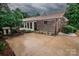 Brick home featuring backyard patio, lush landscaping, mature trees, and brick exterior at 3700 Nw Gainesway Nw Ct, Concord, NC 28027
