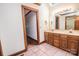 Bathroom with wood trim, a double sink vanity and walk-in closet access at 3700 Nw Gainesway Nw Ct, Concord, NC 28027