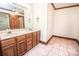 Bathroom featuring a double sink vanity and wood trim throughout at 3700 Nw Gainesway Nw Ct, Concord, NC 28027