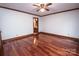 Hardwood bedroom with wood trim, ceiling fan, and ensuite bath at 3700 Nw Gainesway Nw Ct, Concord, NC 28027