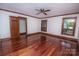 A bedroom with hardwood floors, natural light from multiple windows, neutral walls, and ceiling fan at 3700 Nw Gainesway Nw Ct, Concord, NC 28027